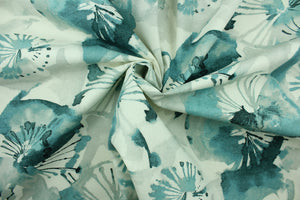  This fabric features a large floral design in shades of blue, with hints of gray set against a white background . 