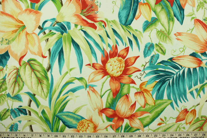  This outdoor fabric features a tropical floral design in orange, golden yellow, green, brown, turquoise, teal and peach set against a dull white. 