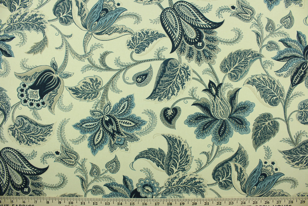 This fabric features a floral design in dark blue. beige, and natural.