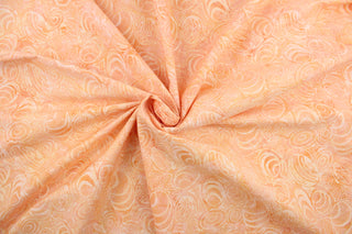  This fabric features seashells in apricot.  It has a nice soft hand and would be great for quilting, crafting and home decor.  We offer this fabric in one other color.