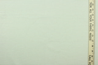 This fabric features a ticking stripe design in light beige and white. 