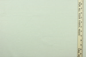 This fabric features a ticking stripe design in light beige and white. 