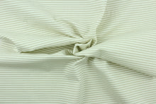 Load image into Gallery viewer, This fabric features a ticking stripe design in light beige and white. 
