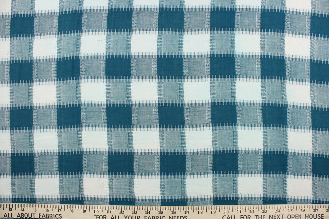 This fabric features a plaid design in teal and white.  It has a nice soft hand and would be great for quilting, crafting and home decor.  We offer this fabric in several different colors.