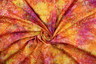 This fabric features a large floral leaf pattern in orange, yellow, purple, green, pink and brown.  It has a nice soft hand and would be great for quilting, crafting and home decor.  