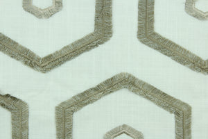Leigh is an embroidered fabric that features an embossed geometric design in in taupe on a natural background.  Uses include drapery, upholstery, pillows and bedding.