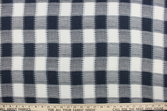 This fabric features a plaid design in dark blue, grey and white.  It has a nice soft hand and would be great for quilting, crafting and home decor.  We offer this fabric in several different colors.