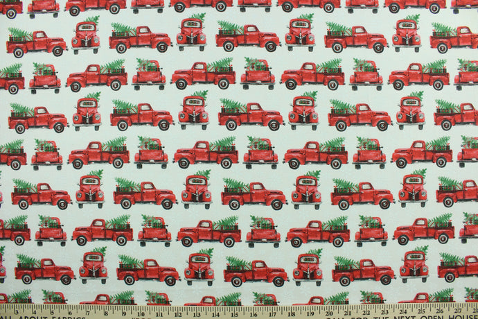 This cotton print fabric features an old pickup truck loaded with a Christmas tree and presents on a white snowflake background.  It has a nice soft hand and would be great for quilting, crafting and home décor.  