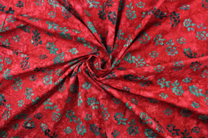 This fabric features small flowers in  dark green on a red background.  It has a nice soft hand and would be great for quilting, crafting and home decor.  