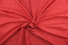 Load image into Gallery viewer, This fabric features dainty white bows with polka dots on a solid red background.  It has a nice soft hand and would be great for quilting, crafting and home decor.  
