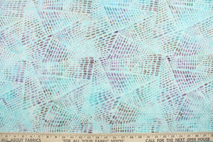 This fabric features a geometric design in varying shades of aqua and purple.  It has a nice soft hand and would be great for quilting, crafting and home decor.  