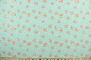 This cotton print fabric features a beautiful kaleidoscope of flowers in turquoise, orange and white.  It has a nice soft hand and would be great for quilting, crafting and home décor.  