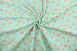 This cotton print fabric features a beautiful kaleidoscope of flowers in turquoise, orange and white.  It has a nice soft hand and would be great for quilting, crafting and home décor.  