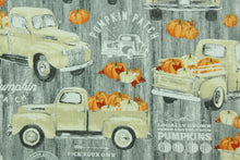 Load image into Gallery viewer, Welcome the Fall with this harvest print featuring an old pickup truck loaded with pumpkins.  Colors included are orange, gray, white and beige.  It has a nice soft hand and would be great for quilting, crafting and home decor.  
