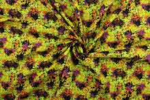 Load image into Gallery viewer, This fabric features a splatter design in Halloween colors of orange, purple, black, white and purple on a lime green background.  It has a nice soft hand and would be great for quilting, crafting and home decor.  
