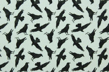 Load image into Gallery viewer, Murder of the Crows features black birds on a white background.  This lightweight fabric is easy to sew and has a soft hand.   The versatile fabric makes it great for quilting, crafting and home decor.
