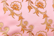 Load image into Gallery viewer, Elegant portrays this jacquard fabric which features intricate woven flowers in gold on a pink background.  Made of 100% polyester this fabric is durable, strong, and wrinkle resistant and has a luxurious feel.  This fabric would compliment any room whether you use it for drapery or throw pillows.  It is also perfect for upholstery, home décor, duvet covers and apparel. The possibilities are endless.  
