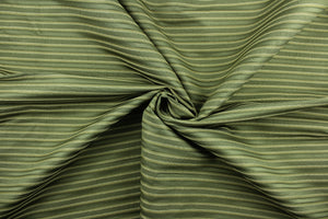  This rich woven yarn dyed fabric features a striped design in shades of green.  Enhancing the color and texture of the stripes is a slight sheen.  Heavy weight and woven stripes make the 100% polyester fabric durable, strong and fade resistant.  This fabric would enrich any room whether you use it for light upholstery, throw pillows, drapery and home décor.