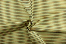 Load image into Gallery viewer, This rich woven yarn dyed fabric features a striped design in green, russet and golden beige.  Enhancing the color and texture of the stripes is a slight sheen.  Heavy weight and woven stripes make the 100% polyester fabric durable, strong and fade resistant.  This fabric would enrich any room whether you use it for light upholstery, throw pillows, drapery and home décor.
