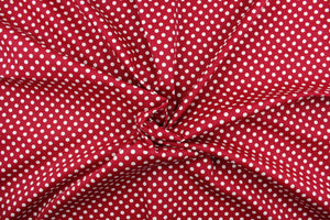 This fun fabric features white polka dots on a red background.  It has a nice soft hand and would be great for quilting, crafting, apparel and home decor.  We offer this fabric in several other colors.