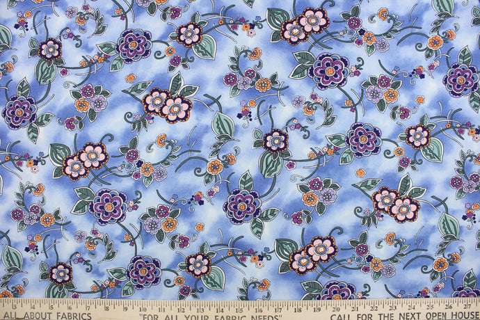 This cute fabric features a floral and vine design in shades of purple, green and orange on a blue cloud background.  It has a nice soft hand and would be great for quilting, crafting, apparel and home decor.  The possibilities are endless.