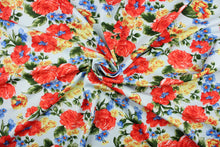 Load image into Gallery viewer, This fabric features a floral design in red, blue and yellow on a light blue background.  It is durable and breathable and will allow movements of the body.  Uses include dance and sports wear, leotards and dresses.  We offer several different lycra fabrics.   
