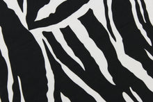 Load image into Gallery viewer, This fun fabric features a zebra print in black and white.  It has a nice soft hand and would be great for quilting, crafting, apparel and home decor.  The possibilities are endless.

