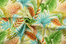 Load image into Gallery viewer, This fabric features large tropical flowers and foliage in shades of green, blue, orange, yellow on an off white background.  It is perfect for outdoor settings or indoors in a sunny room.  It can withstand up to 500 hours of sunlight and is water and stain resistant. Perfect for porches, patios and pool side.  Uses include toss pillows, cushions, upholstery, tote bags and more.  
