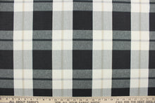 Load image into Gallery viewer, This fabric features a large plaid design in gray, black, khaki and off white.  It is perfect for outdoor settings or indoors in a sunny room.  It can withstand up to 500 hours of sunlight and is water and stain resistant and durable with 10,000 double rubs.  Perfect for porches, patios and pool side.  Uses include toss pillows, cushions, upholstery, tote bags and more.  
