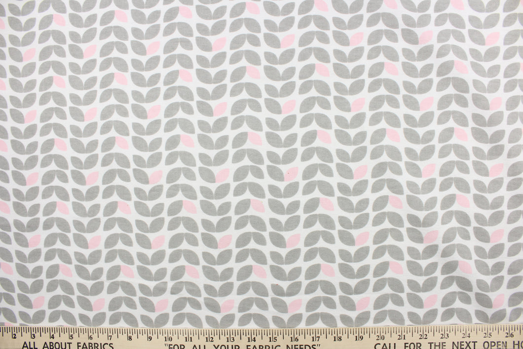 This printed flannel features leaves in gray and pink on a white background.  Uses include apparel, home decor and crafting.  This fabric has a soft workable feel. 