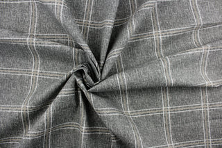 This fabric features a plaid design in gray, white and brown.  It is perfect for outdoor settings or indoors in a sunny room.  It can withstand up to 500 hours of sunlight and is water and stain resistant.  Perfect for porches, patios and pool side.  Uses include toss pillows, cushions, upholstery, tote bags and more. 