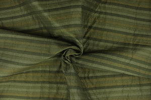  This rich woven yarn dyed fabric features a striped design in shades of green.  Enhancing the color and texture of the stripes is a slight sheen.  Heavy weight and woven stripes make the 100% polyester fabric durable, strong and fade resistant.  This fabric would enrich any room whether you use it for upholstery, throw pillows or home décor.