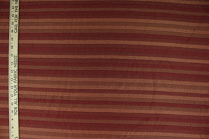 This rich woven yarn dyed fabric features a striped design in shades of red.  Enhancing the color and texture of the stripes is a slight sheen.  Heavy weight and woven stripes make the 100% polyester fabric durable, strong and fade resistant.  This fabric would enrich any room whether you use it for upholstery, throw pillows or home décor.