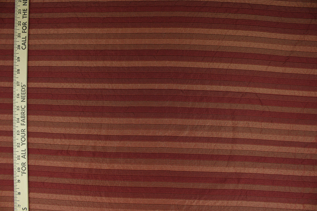 This rich woven yarn dyed fabric features a striped design in shades of red.  Enhancing the color and texture of the stripes is a slight sheen.  Heavy weight and woven stripes make the 100% polyester fabric durable, strong and fade resistant.  This fabric would enrich any room whether you use it for upholstery, throw pillows or home décor.