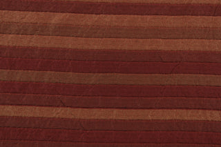 This rich woven yarn dyed fabric features a striped design in shades of red.  Enhancing the color and texture of the stripes is a slight sheen.  Heavy weight and woven stripes make the 100% polyester fabric durable, strong and fade resistant.  This fabric would enrich any room whether you use it for upholstery, throw pillows or home décor.