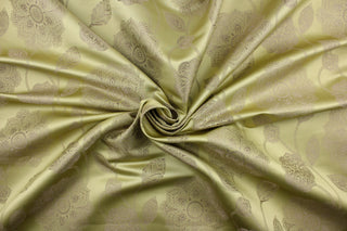 This fabric features a large-scale floral pattern in taupe on a spring green background.  The slight sheen enhances the design.  It would be great for home decor such as multi-purpose upholstery, window treatments, pillows, duvet covers, tote bags and more.  It has a soft workable feel yet is stable and durable.