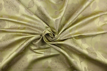 Load image into Gallery viewer, This fabric features a large-scale floral pattern in taupe on a spring green background.  The slight sheen enhances the design.  It would be great for home decor such as multi-purpose upholstery, window treatments, pillows, duvet covers, tote bags and more.  It has a soft workable feel yet is stable and durable.

