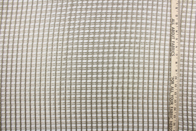 This sheer fabric features a net weave design in a pewter. 