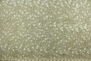 This see through fabric has as firm texture featuring woven mesh lace with metallic gold thread and a scalloped border.  It is perfect for special occasion apparel, costumes, overlays, table tops and decorations.  