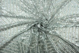 Sparkle and shimmer with this beautiful geometric design in silver.  The sheer polyester netting features thousands of sequins for a glitzy touch.  It is perfect for special occasion apparel, costumes, overlays, table tops, decorations and more.
