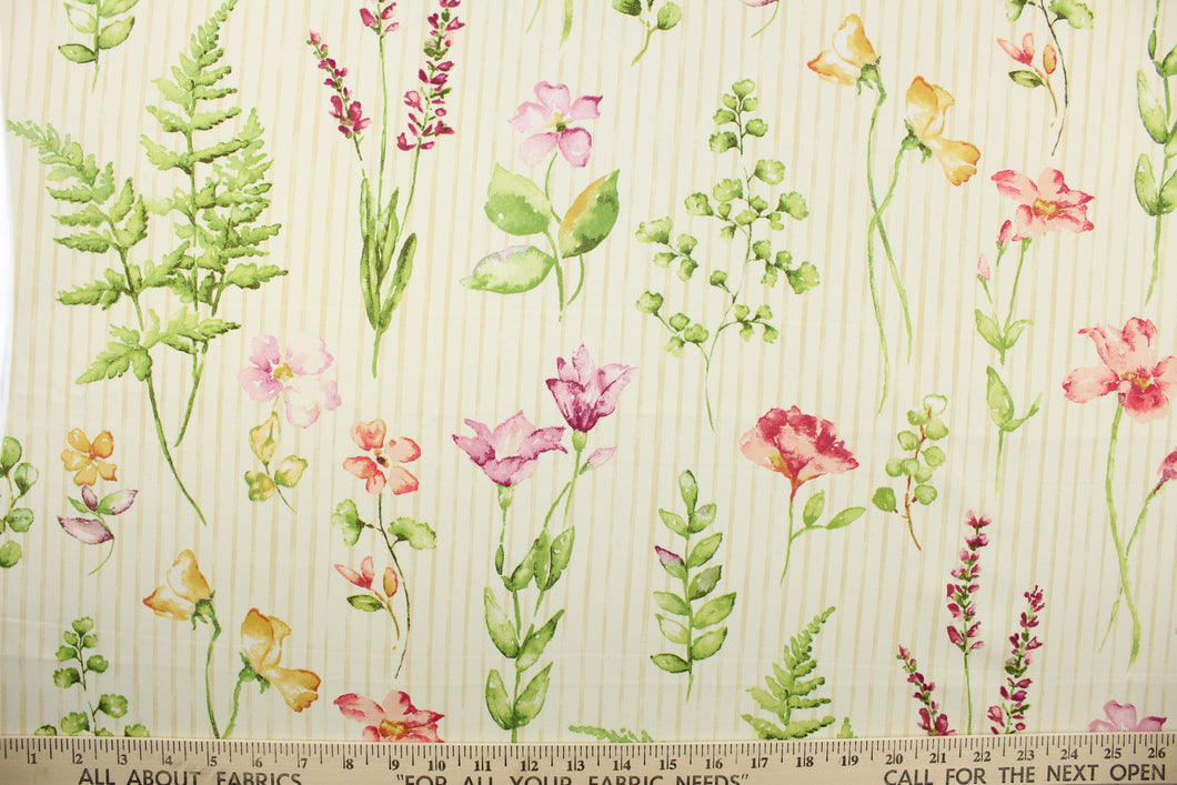  Giardini is a large floral and leaf print with a stripe design in the background.  Colors included are gold, shades of green, lavender, coral, rose and off white against a cream background. 