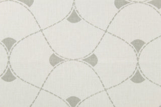 This multi use print fabric in cotton features a large geometrical design in white and gray