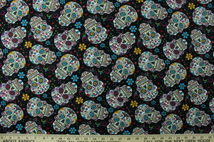 Folkloric skulls features bright and colorful sugar skulls with floral details on a black background.  Colors include magenta, blue, yellow, green, white and red.  The lightweight fabric is easy to sew and has a soft hand.  This versatile fabric makes it great for quilting, crafting and home décor.