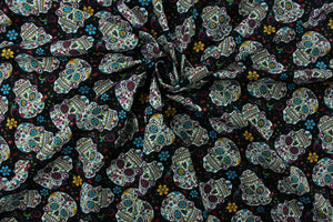 Folkloric skulls features bright and colorful sugar skulls with floral details on a black background.  Colors include magenta, blue, yellow, green, white and red.  The lightweight fabric is easy to sew and has a soft hand.  This versatile fabric makes it great for quilting, crafting and home décor.