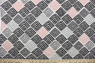 This multi use fabric features an abstract design in black, grey, white and pink.