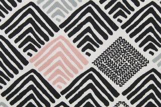 This multi use fabric features an abstract design in black, grey, white and pink.