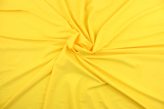 An 8 way lycra  fabric in a solid bright yellow . 
