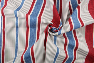 This multi use fabric features a heavy striped design in red, blue, gray and white. 
