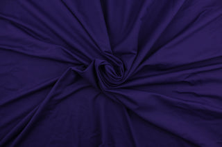  A 8 way stretch jersey lycra in a solid rich purple . 