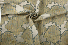 Load image into Gallery viewer, This fabric features a honeycomb design in a metallic gold, blue, and taupe .
